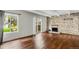 Bright living room boasting hardwood floors, stone fireplace, and sliding glass doors to a deck at 9995 E Harvard Ave # 290, Denver, CO 80231