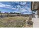 Well-maintained backyard with a dark fence surrounding the property, under a beautiful sky at 1660 Candleflower Dr, Castle Pines, CO 80108