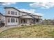 Large backyard featuring a well-maintained lawn, stone patio, and a wooden fence at 1660 Candleflower Dr, Castle Pines, CO 80108