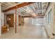 Unfinished basement with exposed beams, concrete floor, and natural light from windows at 1660 Candleflower Dr, Castle Pines, CO 80108