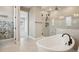 Elegant bathroom with a freestanding tub, glass-enclosed shower, and stylish tile work at 1660 Candleflower Dr, Castle Pines, CO 80108
