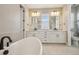 Luxurious bathroom featuring a soaking tub, double vanities, and modern fixtures at 1660 Candleflower Dr, Castle Pines, CO 80108