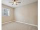 Bright bedroom with neutral tones, plush carpet, and a modern ceiling fan at 1660 Candleflower Dr, Castle Pines, CO 80108