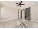 Light bedroom with ceiling fan, a sliding barn door to an ensuite bathroom, and carpeted floors at 1660 Candleflower Dr, Castle Pines, CO 80108