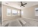 Bright and airy bedroom with large windows and a ceiling fan for added comfort at 1660 Candleflower Dr, Castle Pines, CO 80108