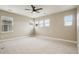 Bright bedroom with plush carpet, ceiling fan, and multiple windows allowing ample natural light at 1660 Candleflower Dr, Castle Pines, CO 80108