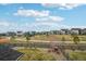 Scenic view of the community playground, walking trails, and new construction homes on a cloudy day at 1660 Candleflower Dr, Castle Pines, CO 80108