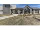 Modern Canyon House exterior featuring stone and wood accents, a metal roof, and manicured landscaping at 1660 Candleflower Dr, Castle Pines, CO 80108