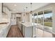 Modern kitchen with stainless steel appliances, a large island, white cabinets, and sliding doors to the outside at 1660 Candleflower Dr, Castle Pines, CO 80108