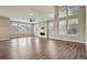 Bright living room with large windows, high ceilings, modern ceiling fan, fireplace and wood floors at 1660 Candleflower Dr, Castle Pines, CO 80108