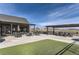 Spacious outdoor patio area with tables, chairs, and umbrellas, perfect for relaxing and entertaining at 1660 Candleflower Dr, Castle Pines, CO 80108