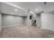 Spacious finished basement with neutral carpet, gray walls, recessed lighting and stairs to another level at 8712 W 64Th Way, Arvada, CO 80004