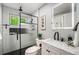 Modern bathroom featuring a black framed shower with white subway tile, black accents, and a stylish vanity at 8712 W 64Th Way, Arvada, CO 80004