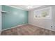 This bedroom features an empty closet, neutral carpet, and a gray and teal accent wall at 8712 W 64Th Way, Arvada, CO 80004