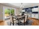 Contemporary dining area boasting hardwood floors, sliding glass doors to backyard access, and a feature wall at 8712 W 64Th Way, Arvada, CO 80004