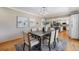 Elegant dining room with a stylish table, hardwood floors, and view of the open concept kitchen at 8712 W 64Th Way, Arvada, CO 80004