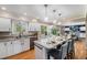 Bright kitchen featuring granite countertops, a large island, and seamless flow into the adjacent dining area at 8712 W 64Th Way, Arvada, CO 80004