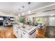 Spacious open-concept kitchen with island seating, stainless appliances, and seamless flow into living and dining areas at 8712 W 64Th Way, Arvada, CO 80004