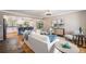 Open living room showcasing hardwood floors, stylish furnishings, and seamless flow into the adjacent kitchen at 8712 W 64Th Way, Arvada, CO 80004