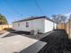 Backyard featuring a concrete pad, gravel landscaping, the side of the house, and a wooden fence at 4947 Saint Paul St, Denver, CO 80216