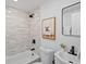 Bright bathroom with a stylish tub, cute art, and sleek fixtures at 4947 Saint Paul St, Denver, CO 80216