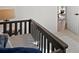 Bedroom detail featuring modern railings and a glimpse into the light-filled living area at 4947 Saint Paul St, Denver, CO 80216