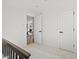 Hallway with neutral carpet, fresh paint, and views of the living room at 4947 Saint Paul St, Denver, CO 80216