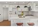 Spacious kitchen with a center island, white cabinets, white countertops, and modern lighting fixtures at 4947 Saint Paul St, Denver, CO 80216