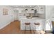 Spacious kitchen with a center island, white cabinets, white countertops, and modern lighting fixtures at 4947 Saint Paul St, Denver, CO 80216