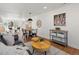 Bright and airy living room with a view into the dining room, featuring a sofa and decorative accents at 4947 Saint Paul St, Denver, CO 80216