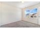 Well-lit bedroom featuring a large window and carpet flooring at 7242 E 133Rd Cir, Thornton, CO 80602