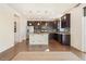 Kitchen with dark cabinets, island, and tile backsplash at 7242 E 133Rd Cir, Thornton, CO 80602