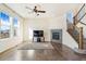 Living room with fireplace, wood floors, and a ceiling fan at 7242 E 133Rd Cir, Thornton, CO 80602