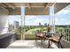 Inviting balcony with wrought iron railings, seating, and stunning park and city views at 1200 N Humboldt St # 1406, Denver, CO 80218