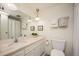 Bathroom featuring marble countertops, white cabinets, and neutral-colored walls and tile at 1200 N Humboldt St # 1406, Denver, CO 80218