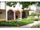 Brick archways with black iron gates and manicured garden at entrance at 1200 N Humboldt St # 1406, Denver, CO 80218