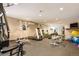 Community gym with workout equipment, mirrors, and rubber flooring at 1200 N Humboldt St # 1406, Denver, CO 80218