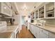 Bright kitchen featuring white cabinets, and open shelving for convenient storage of dishware at 1200 N Humboldt St # 1406, Denver, CO 80218