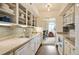 Bright kitchen featuring white appliances, cabinets, and a pass-through to the dining area at 1200 N Humboldt St # 1406, Denver, CO 80218