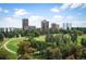 Expansive view of lush park, trees, and cityscape with blue skies and white clouds at 1200 N Humboldt St # 1406, Denver, CO 80218