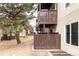 Apartment building exterior featuring private wood balconies and mature trees in the community's landscaping at 9995 E Harvard Ave # 257, Denver, CO 80231