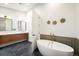 Luxurious bathroom featuring a freestanding tub, dual vanities, and modern lighting at 863 S Race St, Denver, CO 80209