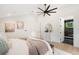 Bright bedroom with hardwood floors, a ceiling fan, and an ensuite bathroom at 863 S Race St, Denver, CO 80209