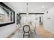 Bright dining room with modern furnishings, view to the entry and a striking black and white rug at 863 S Race St, Denver, CO 80209