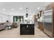 Bright, open-concept kitchen with a large center island and stainless steel appliances at 863 S Race St, Denver, CO 80209