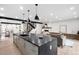 Modern kitchen with a large dark grey island, stylish pendant lighting, and stainless steel accents at 863 S Race St, Denver, CO 80209