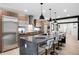 Eat-in kitchen with stainless steel appliances, breakfast bar and modern light fixtures at 863 S Race St, Denver, CO 80209