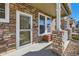 Close-up of a charming front porch, showcasing stone accents and a cozy seating area at 13624 Garfield St # G, Thornton, CO 80602