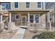 Charming front porch with stone pillars and a decorative white railing at 13624 Garfield St # G, Thornton, CO 80602