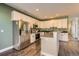 Well-lit kitchen featuring stainless steel appliances, island, and sleek countertops at 13624 Garfield St # G, Thornton, CO 80602